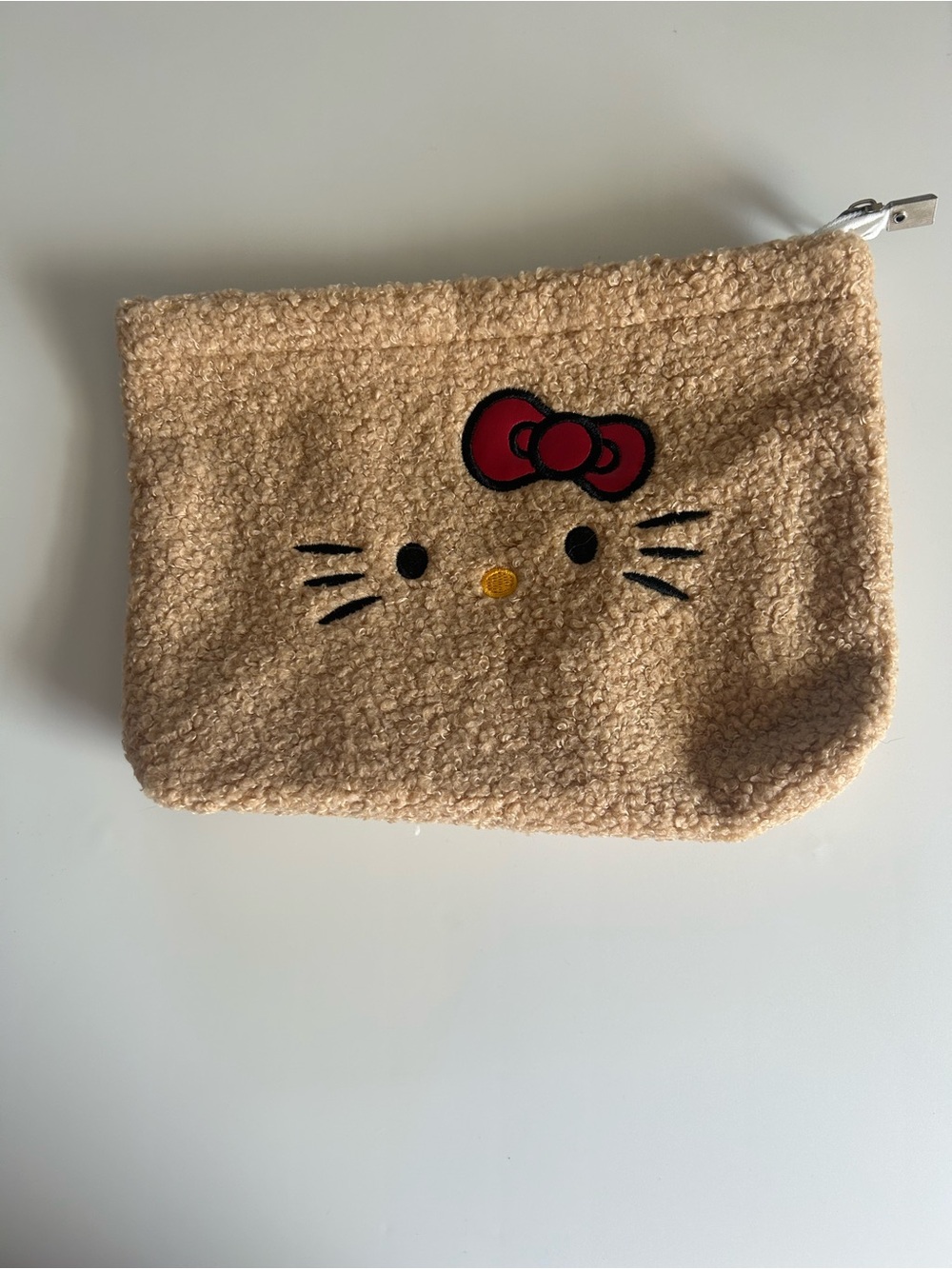 Hello Kitty Beige Sherpa Pouch with Red Bow Accent